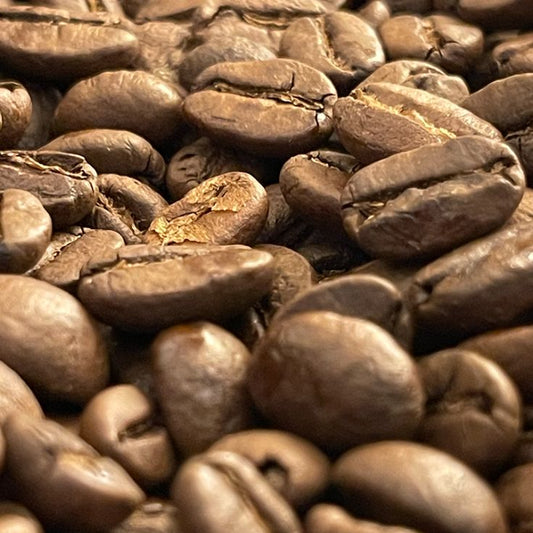 A close-up view of medium-roasted decaffeinated coffee beans