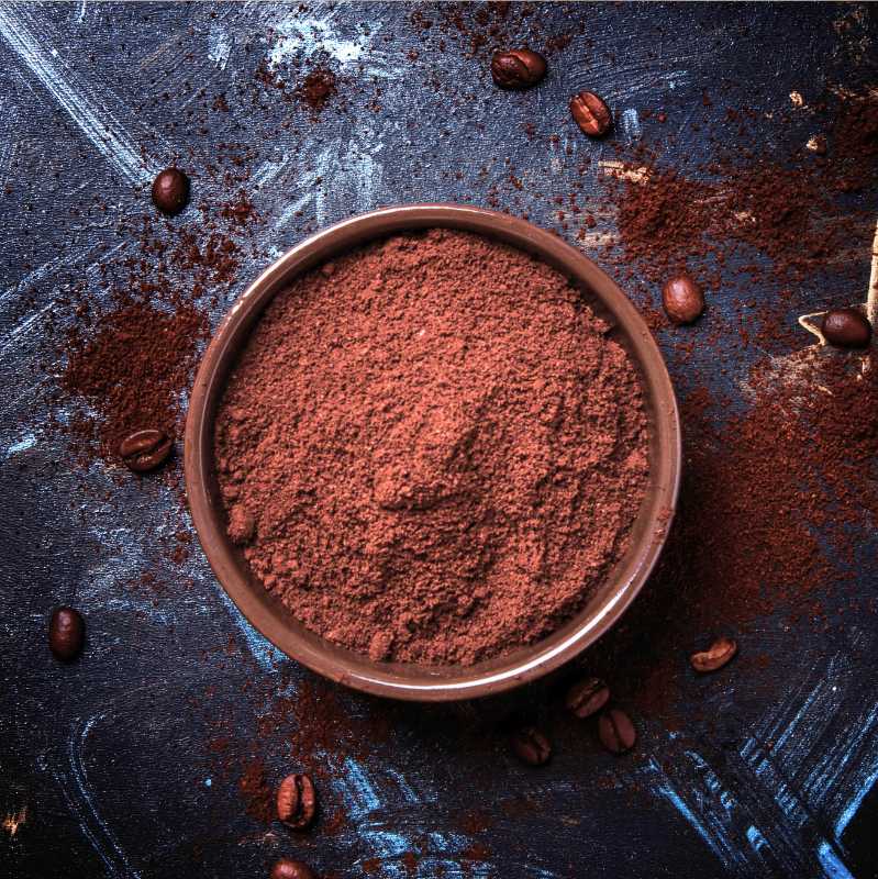 Top view of ground decaf coffee in a portafilter basket